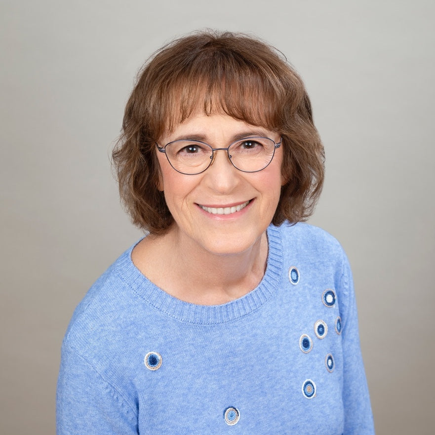 Headshot of author Kathy Kacer wearing a blue sweater